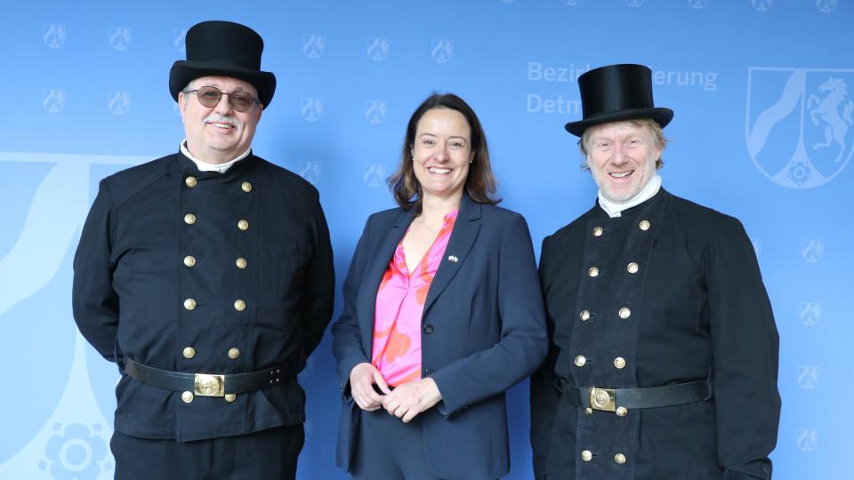 Regierungspräsidentin Anna Katharina Bölling mit dem neuen bevollmächtigten Bezirksschornsteinfeger André Hoffmann (rechts) und Innungsobermeister Dirk Franck.